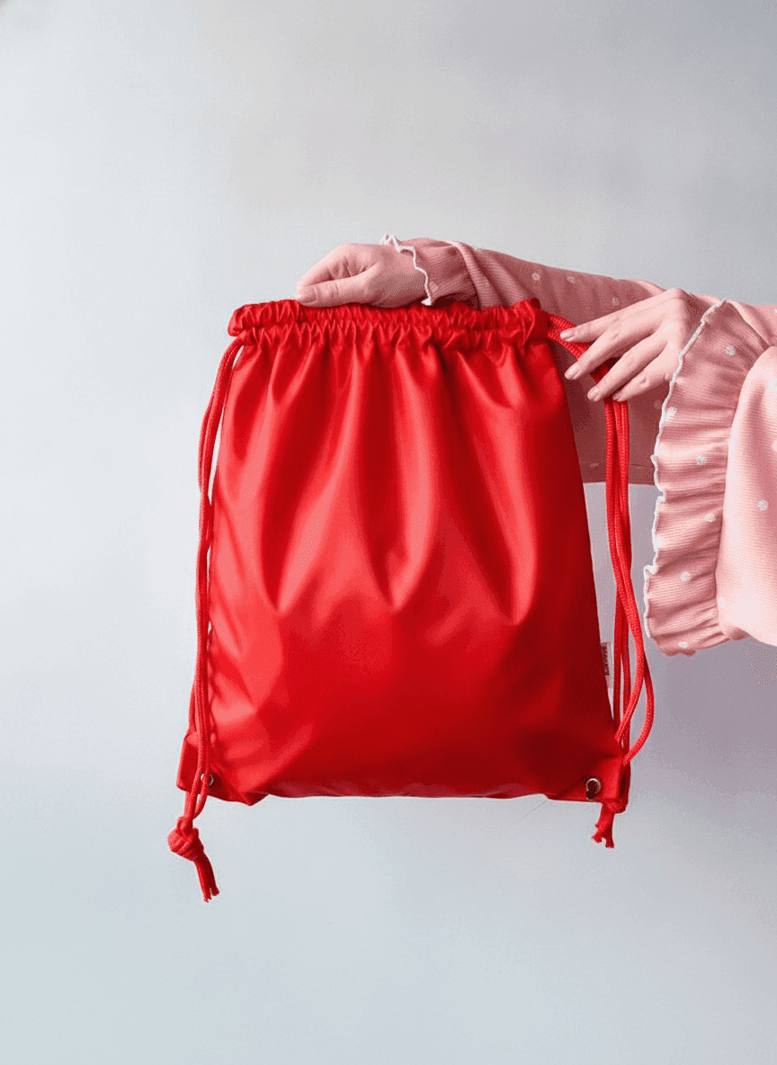 Red water-resistant nylon backpack with reflective strip