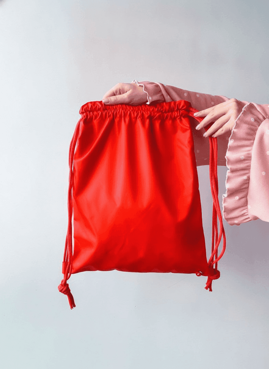 Red water-resistant nylon backpack with reflective strip
