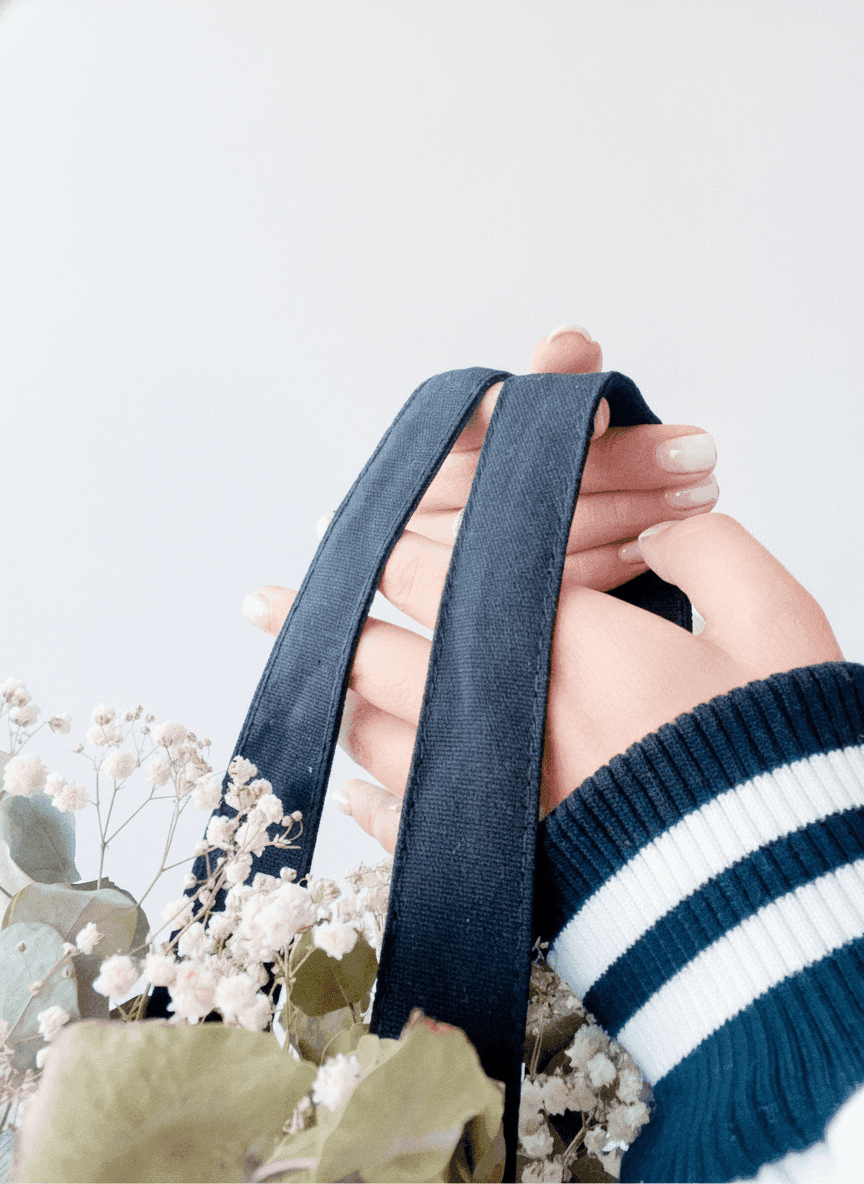 Natural canvas tote bag with black handles