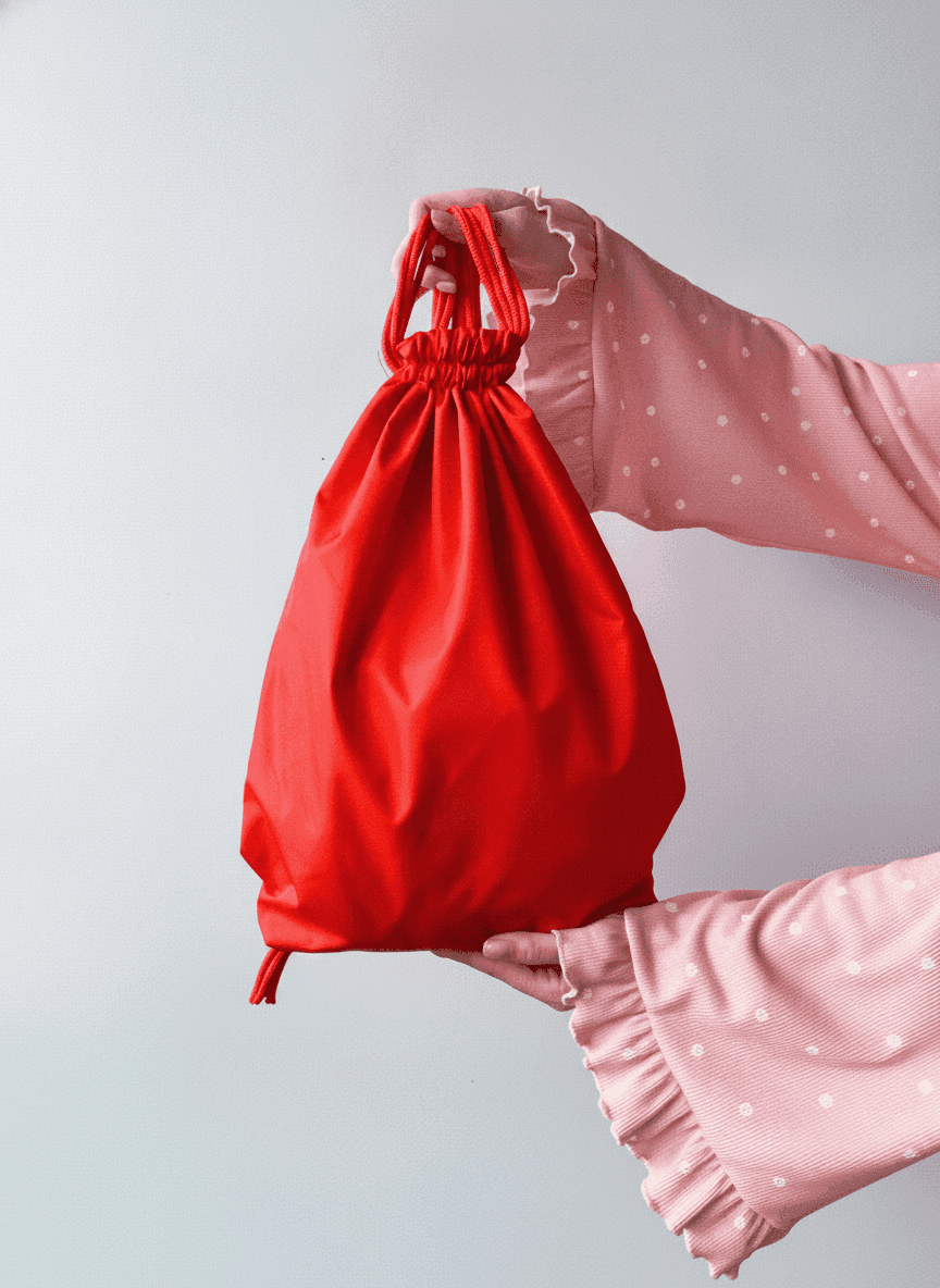 Red water-resistant nylon backpack with reflective strip