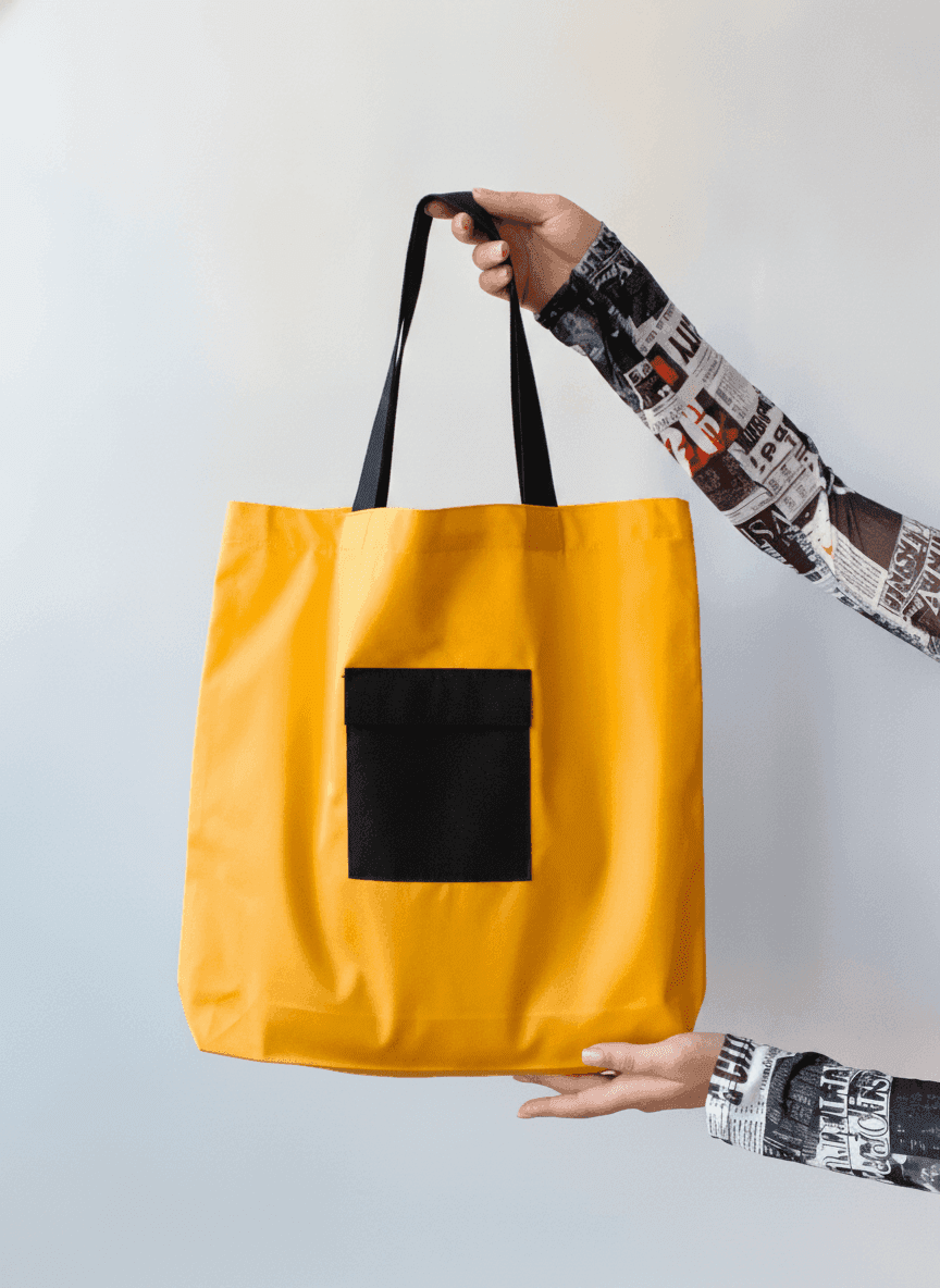 Yellow tote bag with black handles & exterior pocket