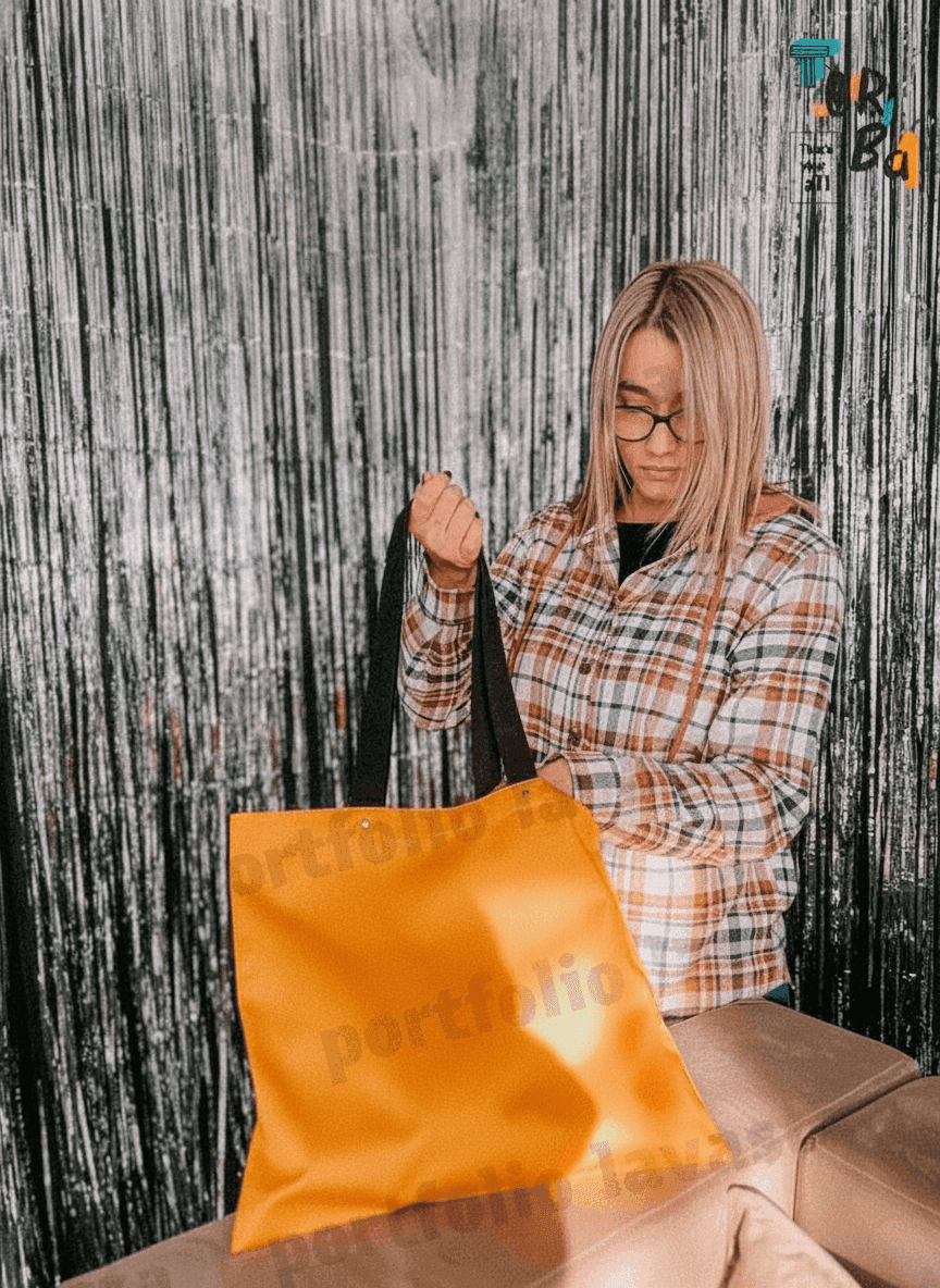 Orange tote bag with rivet handles