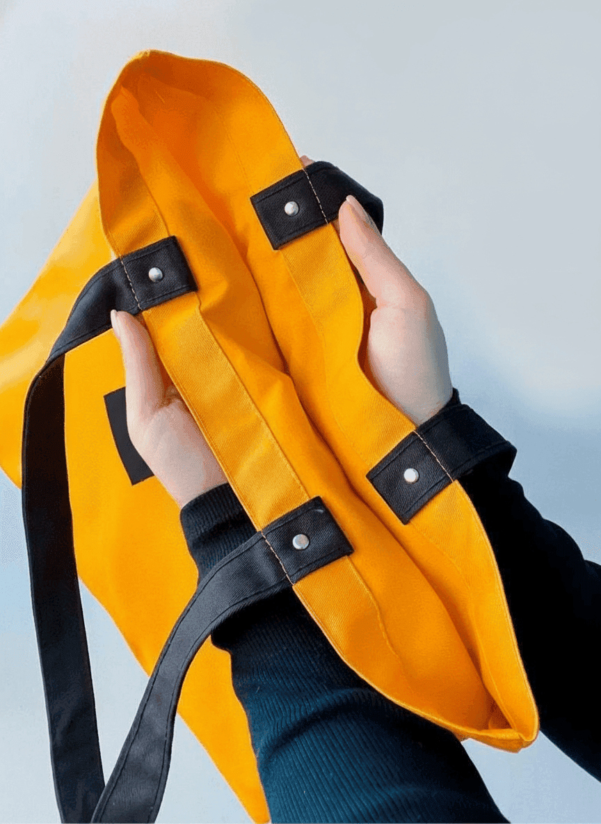 Orange tote bag with rivet handles