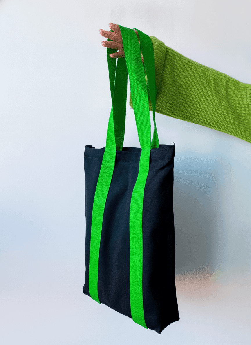 Black tote bag with long green handles